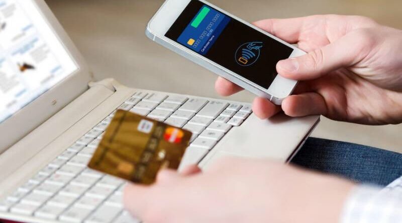 a person holding a credit card and a phone