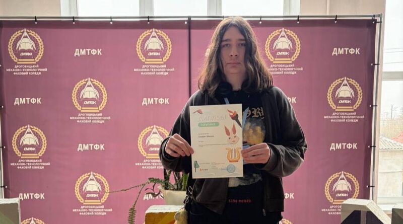 Person holding certificate in college